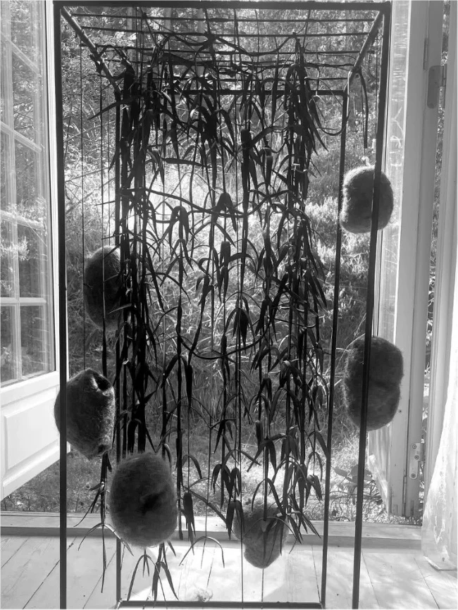 Installation with hanging branches and woollen nests