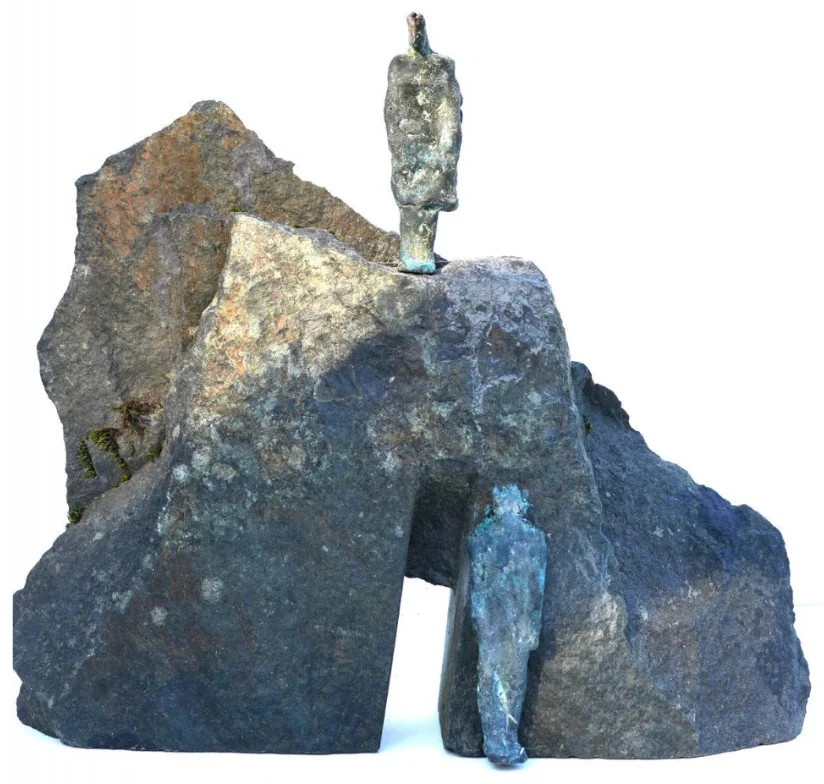 Two small bronze figures on a large stone
